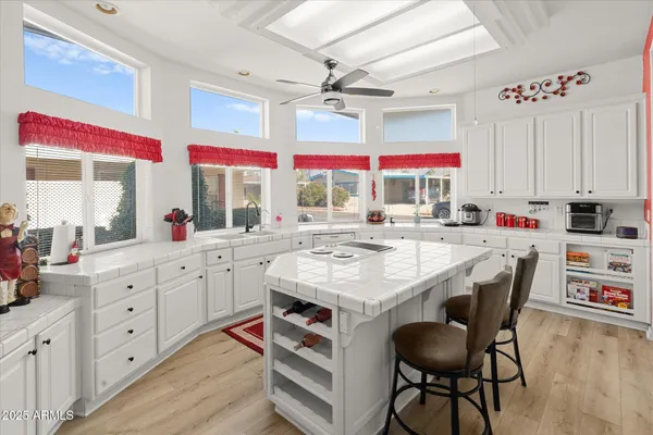 a living room with furniture ceiling fan and a window