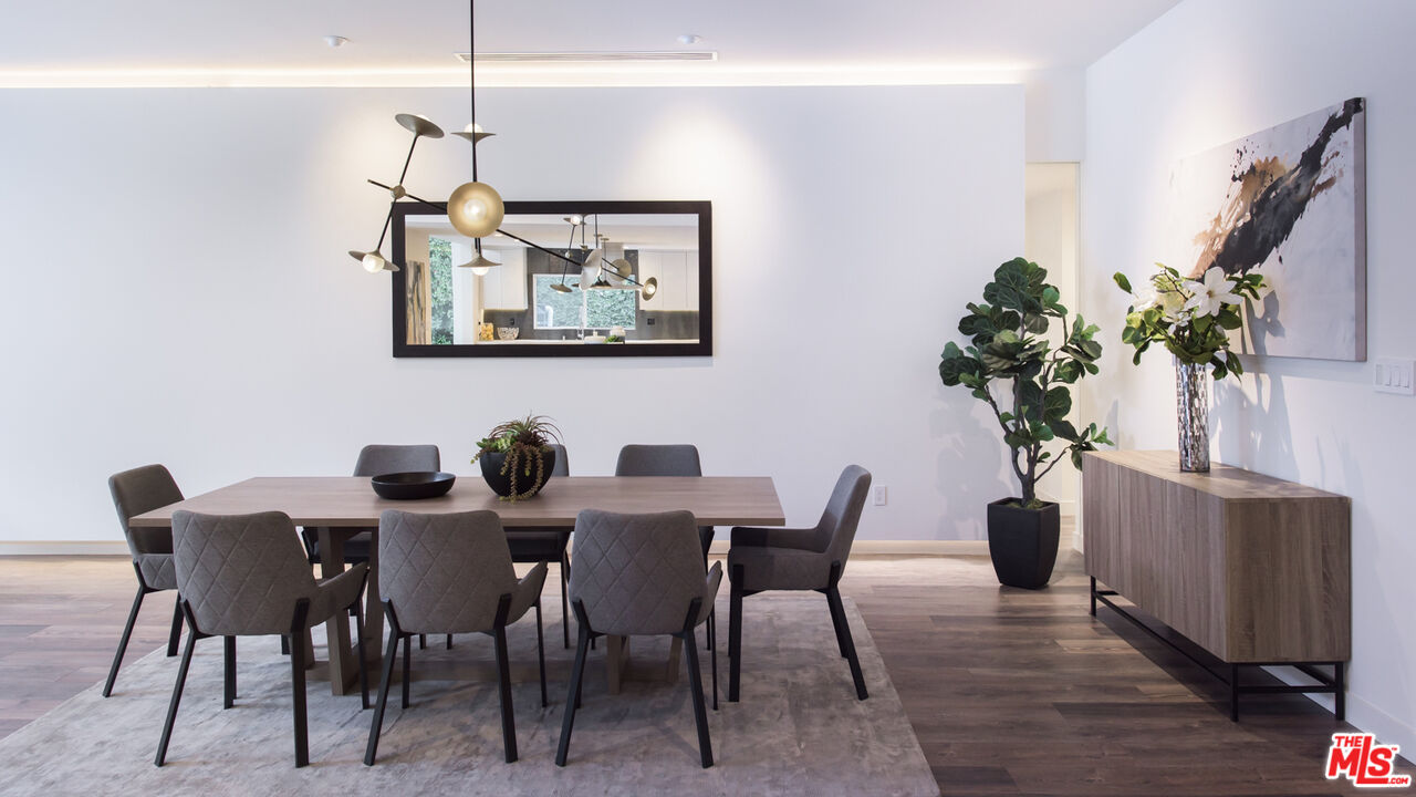 2213 Roscomare Road Los Angeles, CA 90077 - Photo 13 of 46 a view of a dining room with furniture window and wooden floor