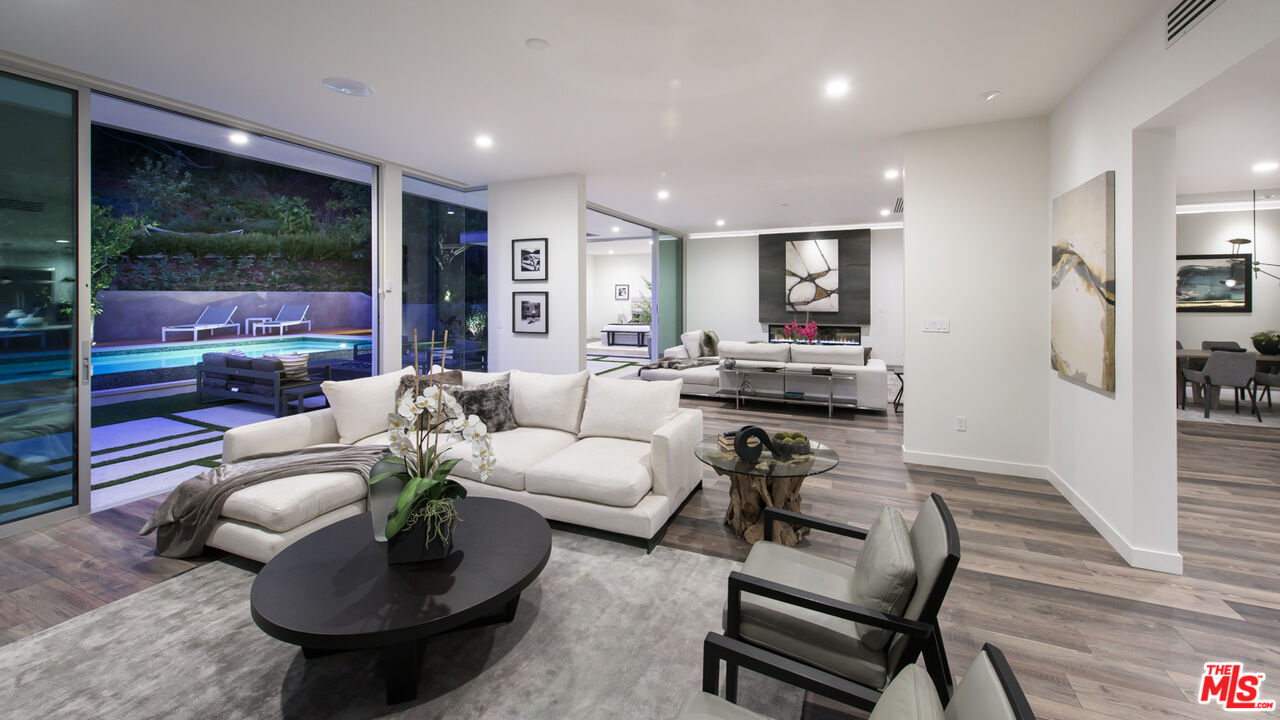 2213 Roscomare Road Los Angeles, CA 90077 - Photo 17 of 46 a living room with furniture and a floor to ceiling window