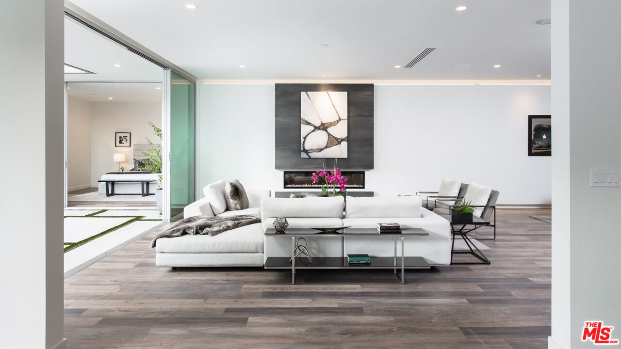 2213 Roscomare Road Los Angeles, CA 90077 - Photo 19 of 46 a living room with furniture and wooden floor