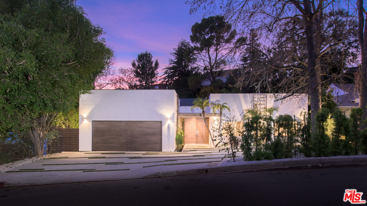2213 Roscomare Road Los Angeles, CA 90077 - Photo 2 of 46 a front view of a house with a yard and garage