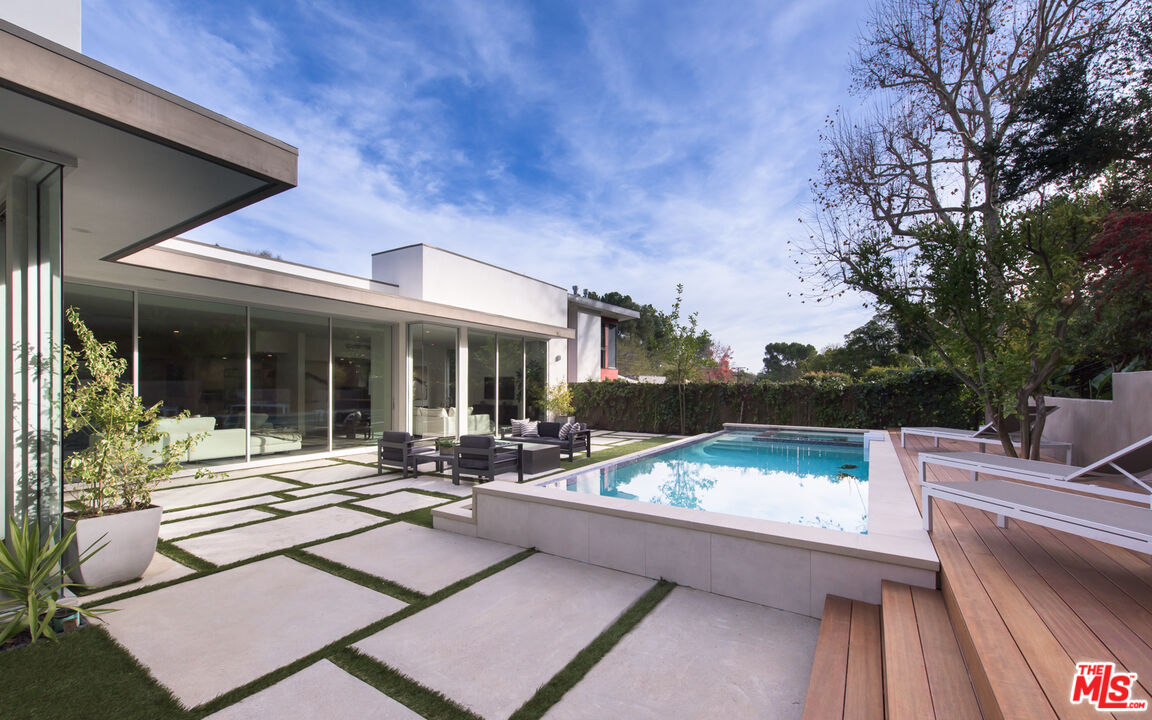 2213 Roscomare Road Los Angeles, CA 90077 - Photo 33 of 46 a view of a patio with couches table and chairs with wooden floor and fence