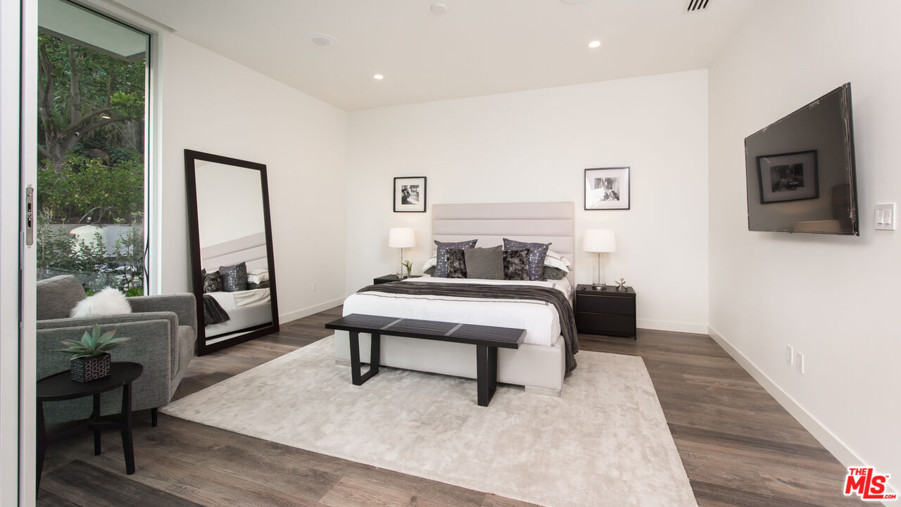 2213 Roscomare Road Los Angeles, CA 90077 - Photo 34 of 46 a bedroom with furniture and a window