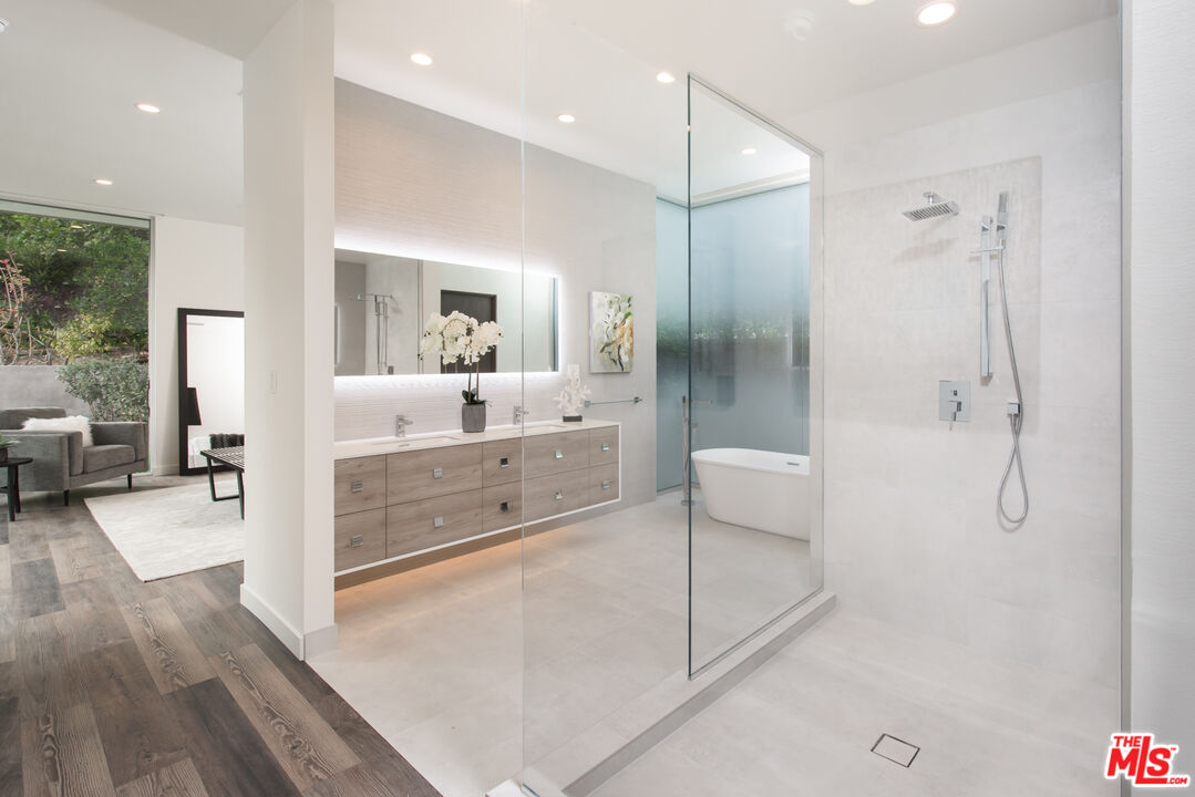 2213 Roscomare Road Los Angeles, CA 90077 - Photo 36 of 46 a bathroom with a double vanity sink mirror and shower