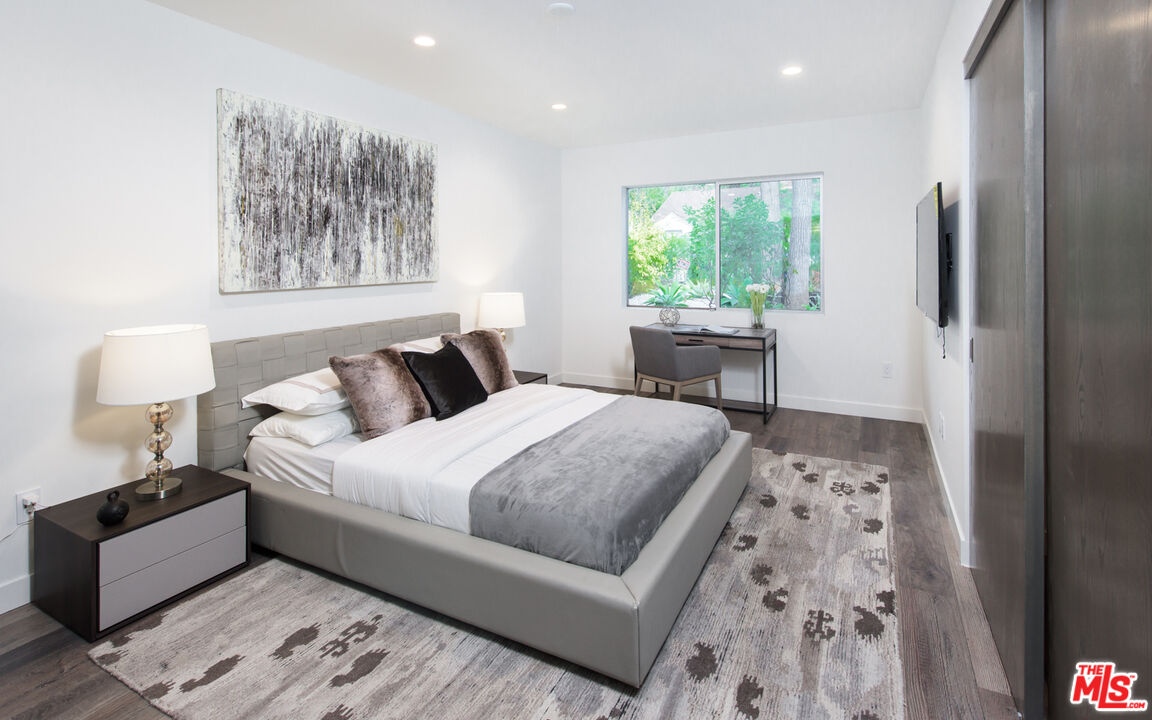 2213 Roscomare Road Los Angeles, CA 90077 - Photo 40 of 46 a bedroom with a large bed and a window