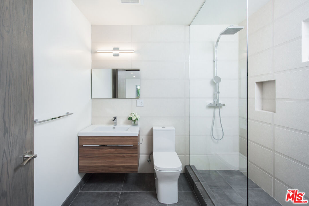 2213 Roscomare Road Los Angeles, CA 90077 - Photo 41 of 46 a bathroom with a sink a toilet and shower