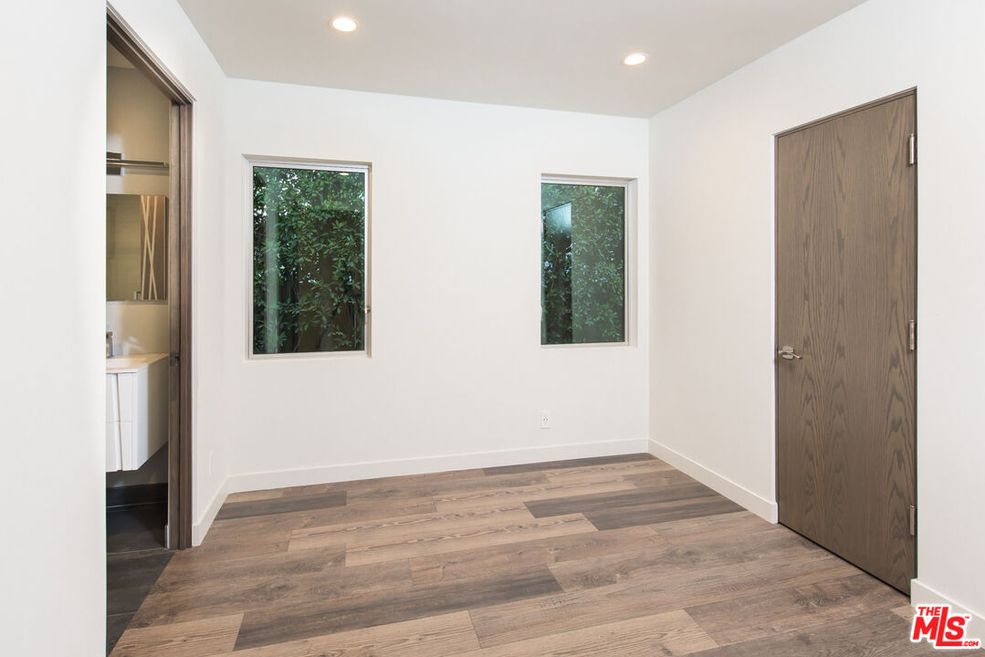 2213 Roscomare Road Los Angeles, CA 90077 - Photo 44 of 46 a view of an empty room with wooden floor and a window