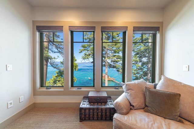 a bedroom with bed and a large window