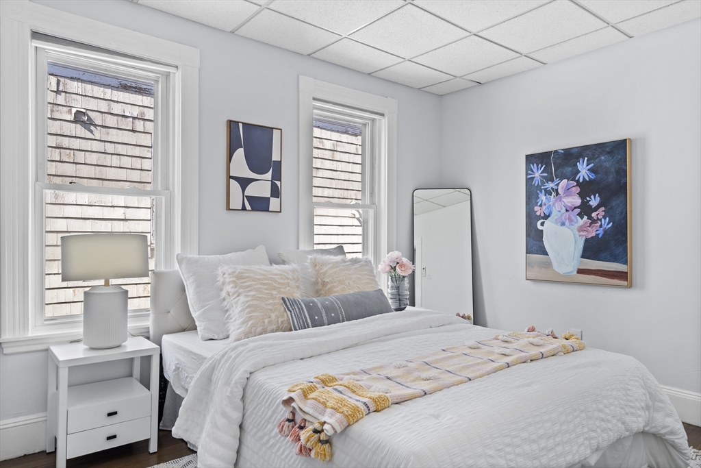 742 Bennington Street, Unit 3 Boston, MA 02128 - Photo 11 of 16 a bedroom with a bed and a painting on the wall