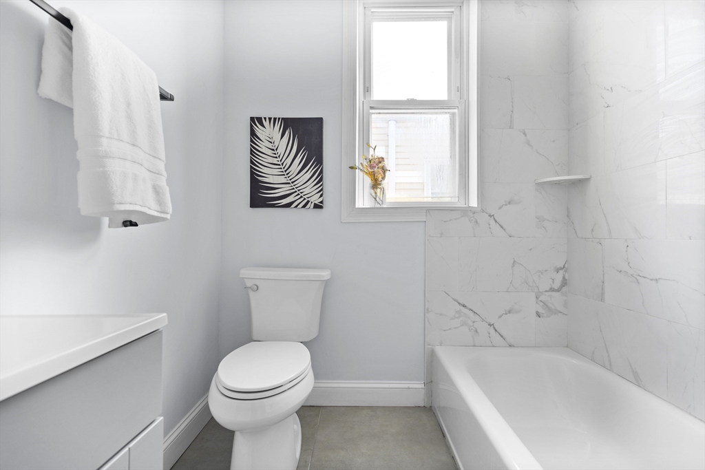 742 Bennington Street, Unit 3 Boston, MA 02128 - Photo 13 of 16 a white toilet sitting next to a bath tub