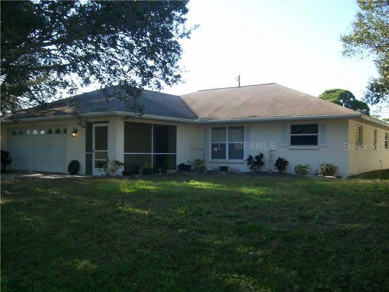 a front view of house with a garden
