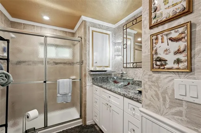 a bathroom with a granite countertop shower a mirror and a sink