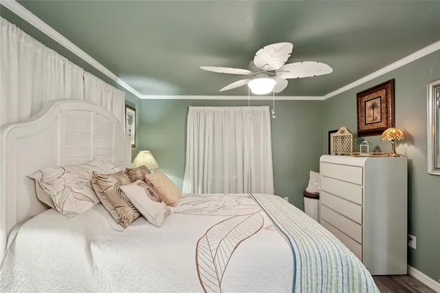 a bedroom with a bed and chandelier
