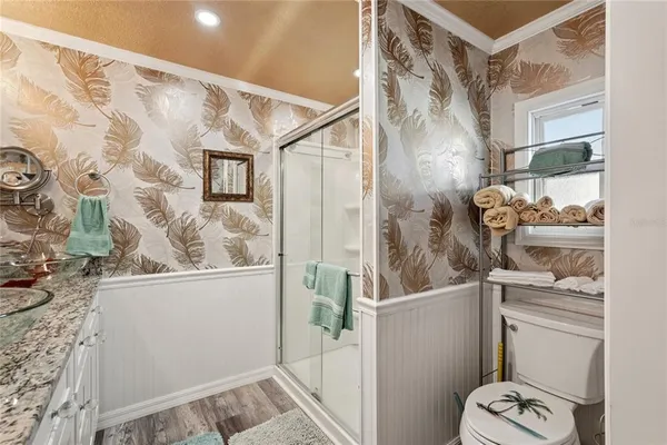 a view of bathroom with a shower and a sink