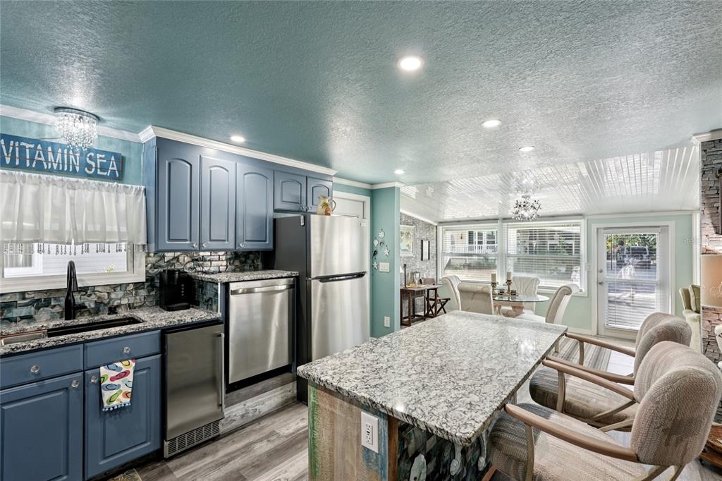 712 Roma Road Venice, FL 34285 - Photo 8 of 24 a kitchen with a table chairs refrigerator and cabinets