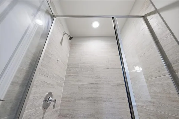 a bathroom with a granite countertop double vanity sink and a mirror