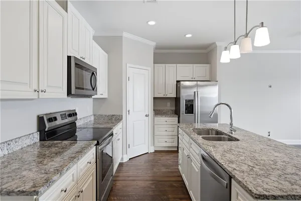 a kitchen with stainless steel appliances granite countertop a sink stove and refrigerator