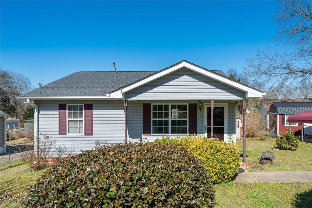 412 Carver Street Anderson, SC 29624 - Photo 1 of 23 This charming home offers comfortable living with a welcoming facade and lush landscaping.