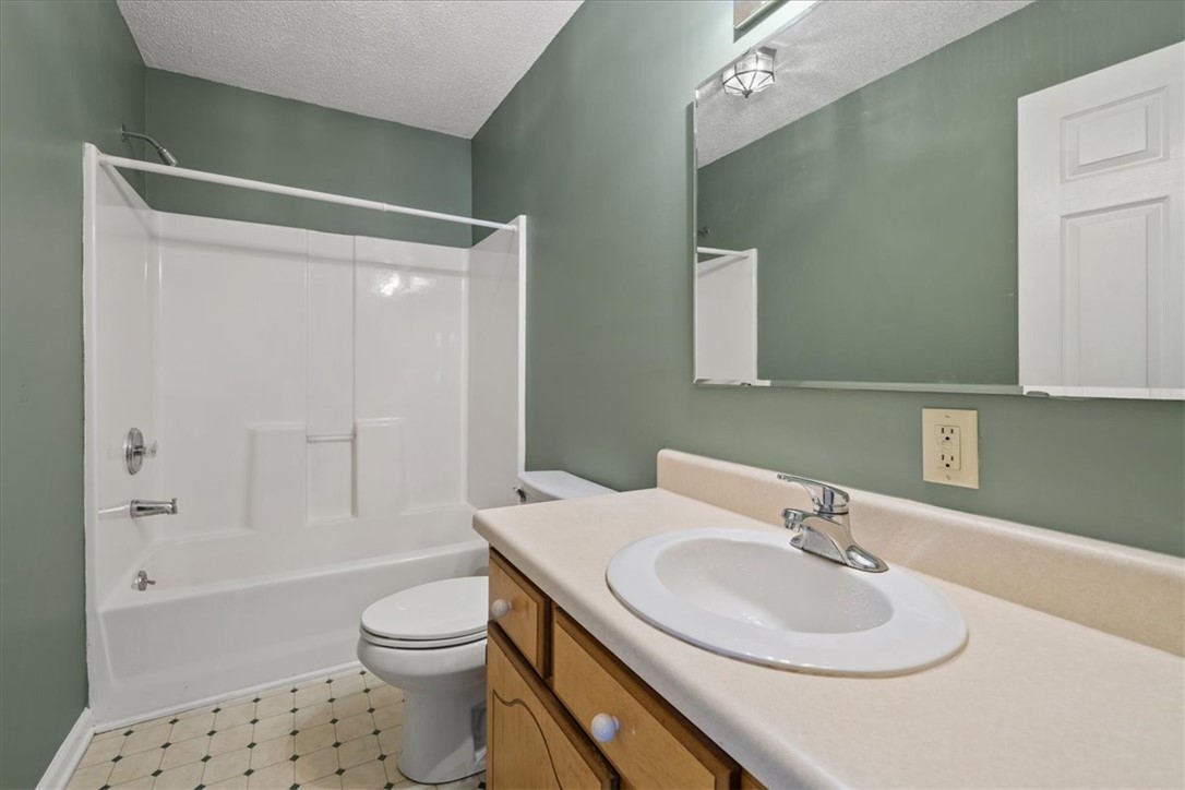 412 Carver Street Anderson, SC 29624 - Photo 15 of 23 This clean bathroom features a convenient shower and toilet, with a well-lit vanity.
