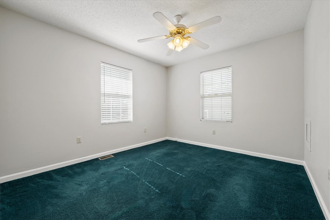 412 Carver Street Anderson, SC 29624 - Photo 16 of 23 This cozy bedroom offers a tranquil retreat with soft carpet and abundant natural light.