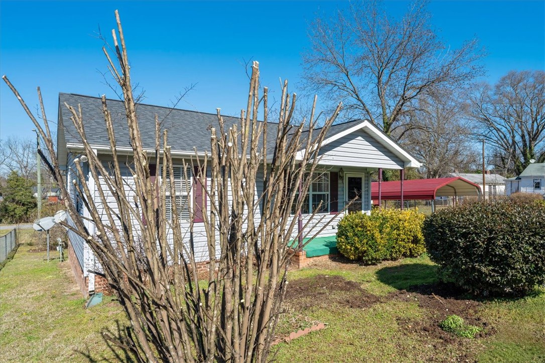 412 Carver Street Anderson, SC 29624 - Photo 2 of 23 This charming home features a classic exterior and lush landscaping, perfect for comfortable living.