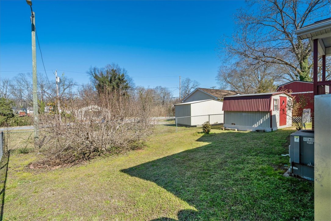 412 Carver Street Anderson, SC 29624 - Photo 21 of 23 This spacious yard includes a chain-link fence and practical storage sheds.