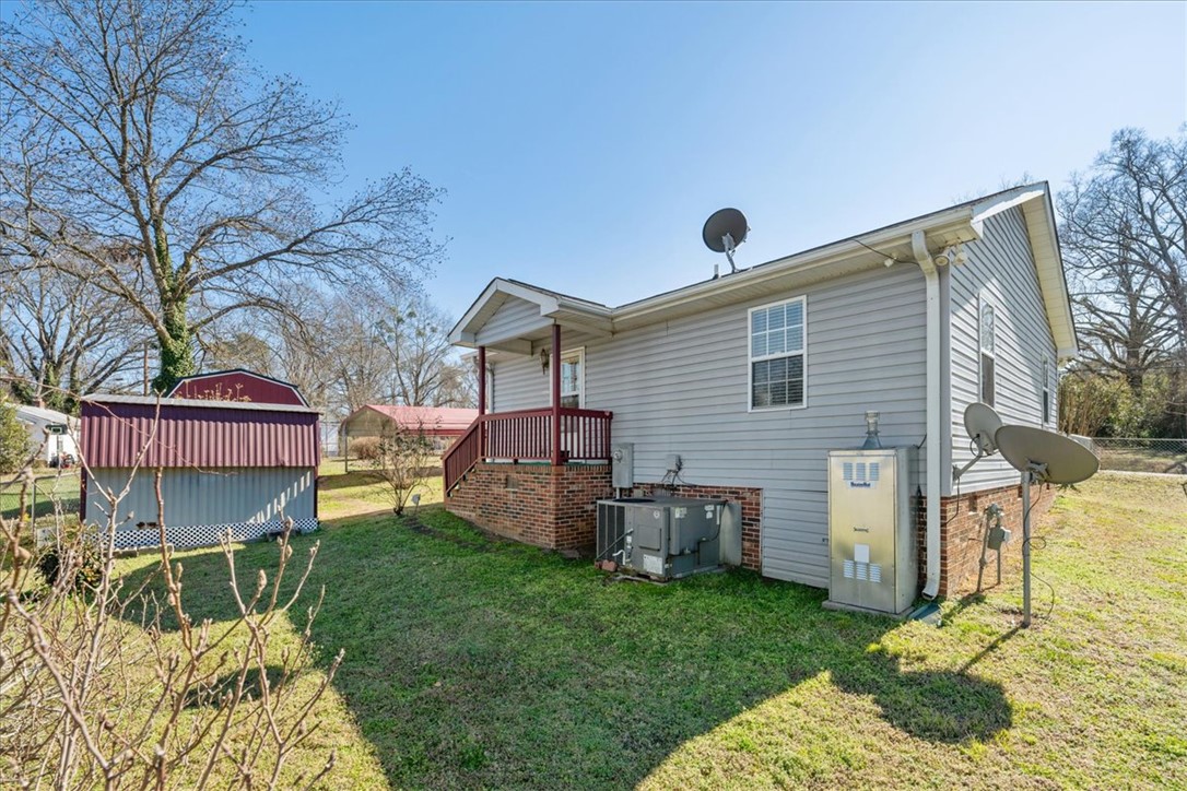 412 Carver Street Anderson, SC 29624 - Photo 22 of 23 This property features a charming side entrance, well-maintained yard, and practical outbuildings.