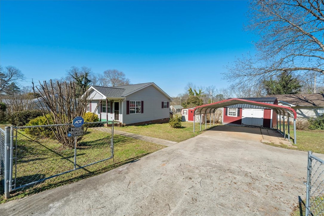 412 Carver Street Anderson, SC 29624 - Photo 3 of 23 This charming home offers a welcoming facade and convenient covered parking, perfect for everyday living.
