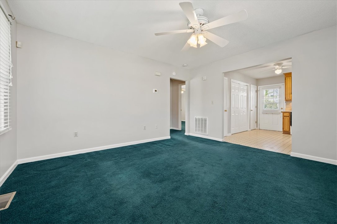 412 Carver Street Anderson, SC 29624 - Photo 7 of 23 This inviting living space features plush carpeting and convenient access to the kitchen.