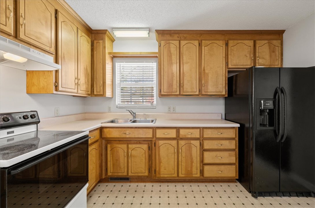 412 Carver Street Anderson, SC 29624 - Photo 9 of 23 This kitchen offers a practical layout with ample cabinetry and essential appliances.