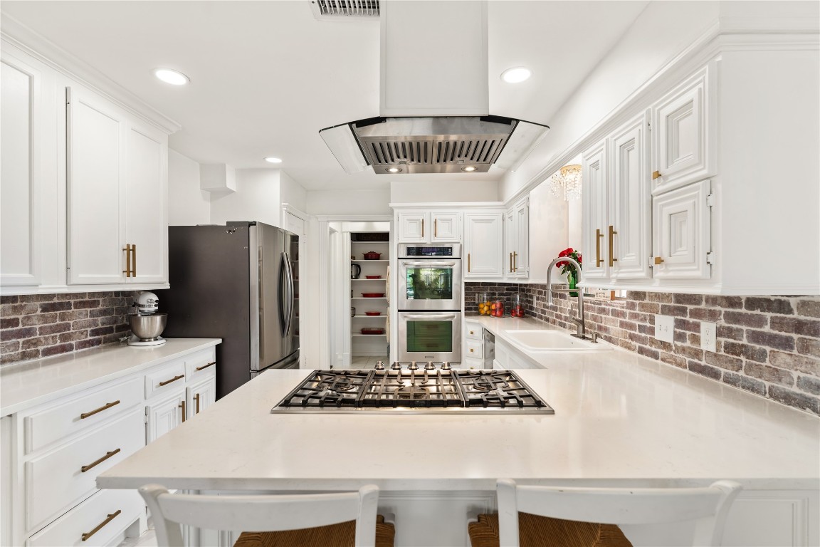 16011 Stratton Park Drive Spring, TX 77379 - Photo 13 of 47 a kitchen with stainless steel appliances a stove a sink and a refrigerator