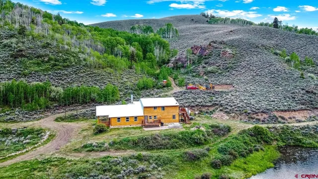 an aerial view of a house with a yard