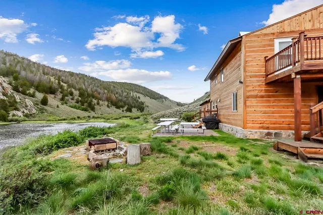 a backyard of a house with table and chairs