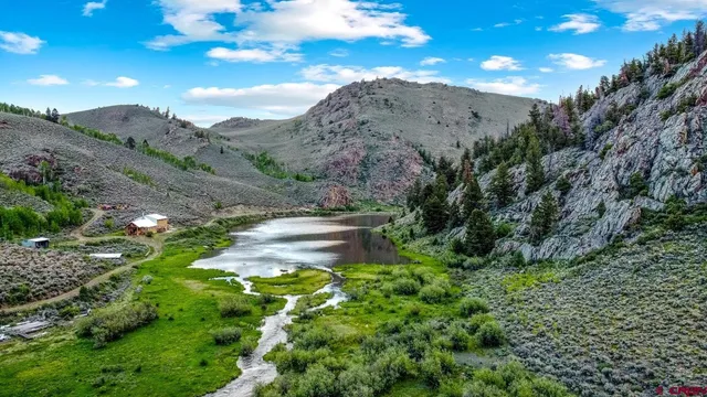 a view of a lush green hillside and a mountain