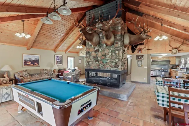 a room with pool table and windows