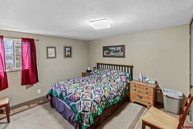 a bed room with a bed and a chair