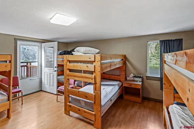 a bedroom with furniture and wooden floor