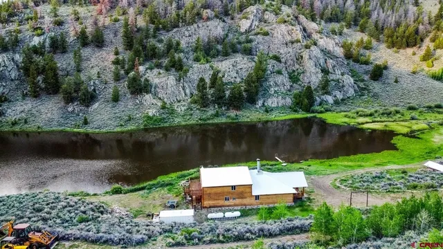 an aerial view of a house with a yard