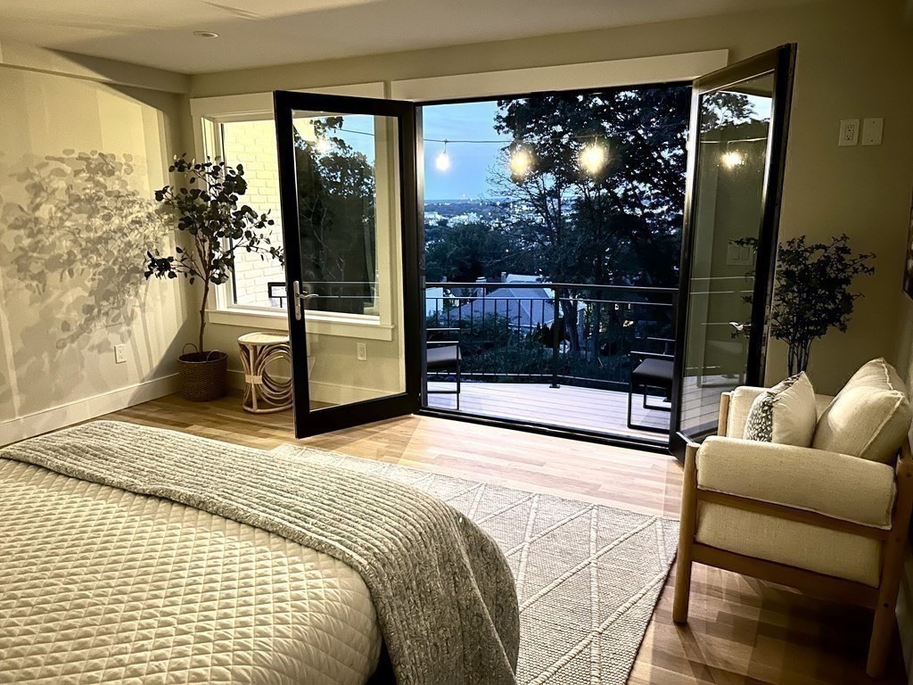 111 Jordan Road Brookline, MA 02446 - Photo 24 of 42 a bedroom with a bed and large window with balcony view