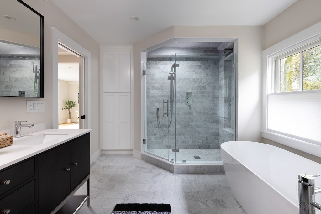 111 Jordan Road Brookline, MA 02446 - Photo 25 of 42 a bathroom with a tub shower sink and mirror