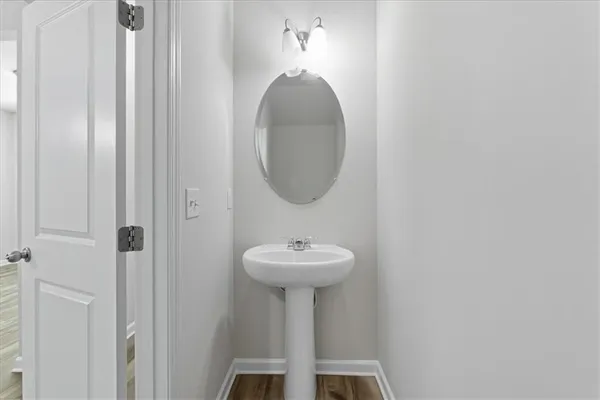 a bathroom with a sink a mirror and a light fixture