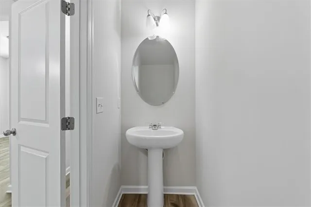 a bathroom with a sink a mirror and a light fixture