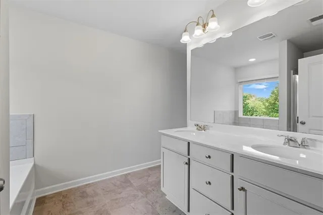 a bathroom with a double vanity sink and a mirror