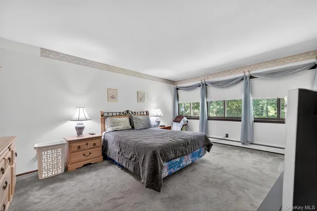 a spacious bedroom with a bed and a large window