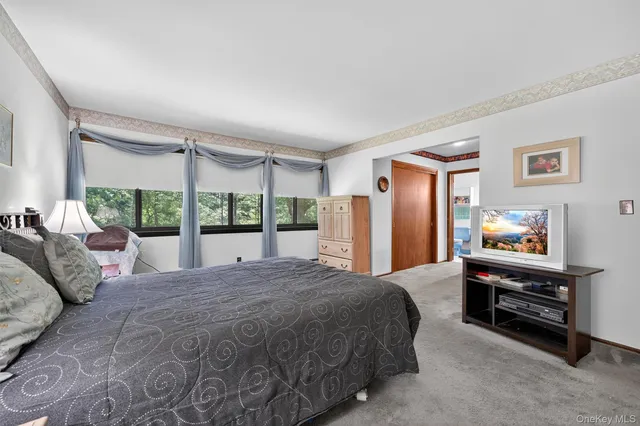 a bed sitting in a bedroom next to a window