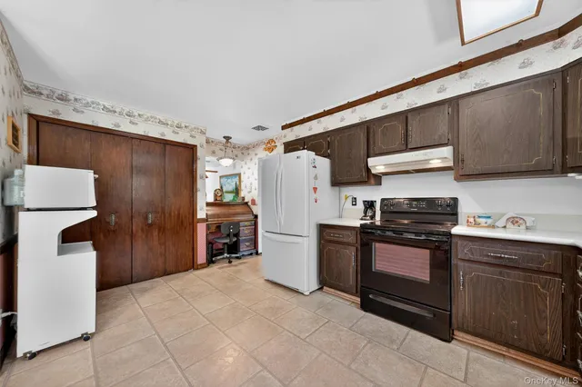 a kitchen with a stove a refrigerator and a sink