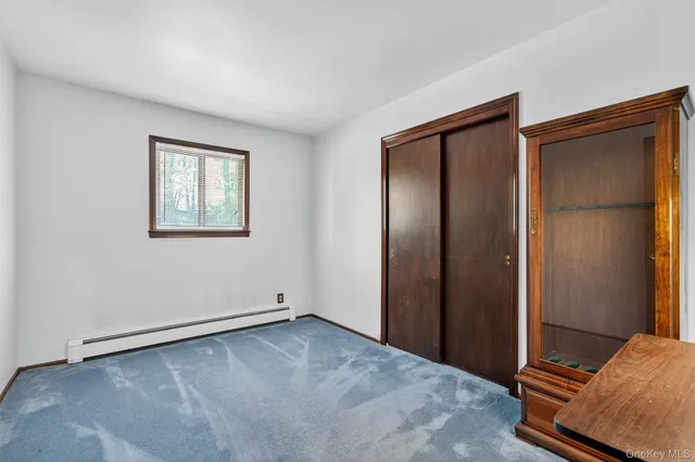 an empty room with windows and closet