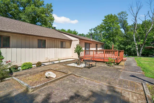 a view of a house with a backyard porch and sitting area