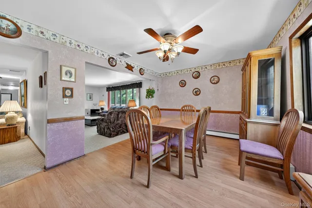 a view of a dining room with furniture and wooden floor