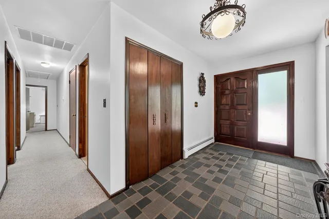 an empty room with closet and windows